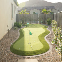 Artificial turf putting green installation in backyard