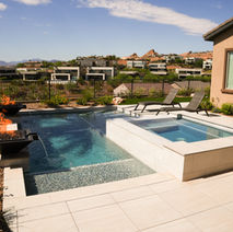 Luxury pool and spa with views of the neighborhood, clear blue water, and landscaping.