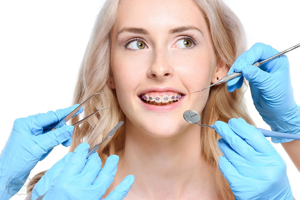 Orthodontist examining a young woman with braces during a dental checkup – Braces for Overbite in Avon and Torrington, Ct.
