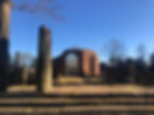 faded image of ruins with blue sky