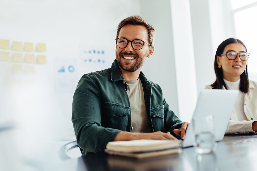 A man smiling in a meeting