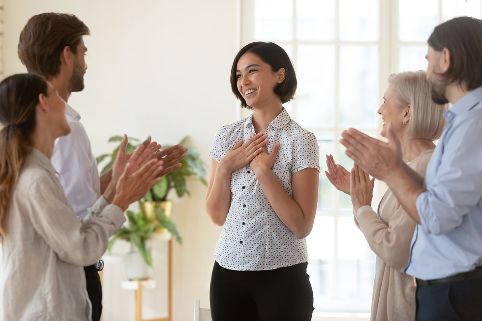 A woman at work being applauded