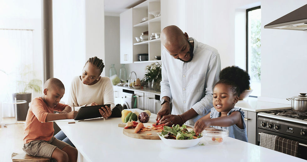 A family preparing food together in a modern kitchen, with kids helping and a cheerful atmosphere