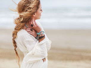 Woman on beach with beaded jewellery