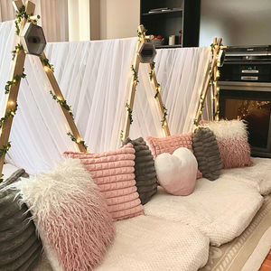 boho style sleepover tents with floral lights and fluffy pillows