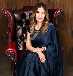 Woman in navy saree sitting