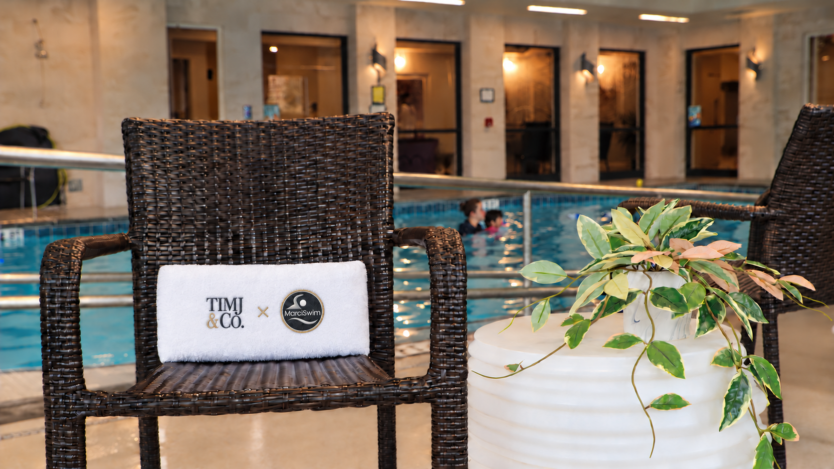 Poolside scene from MarciSwim footage with added collaboration branding and swimmers in the background