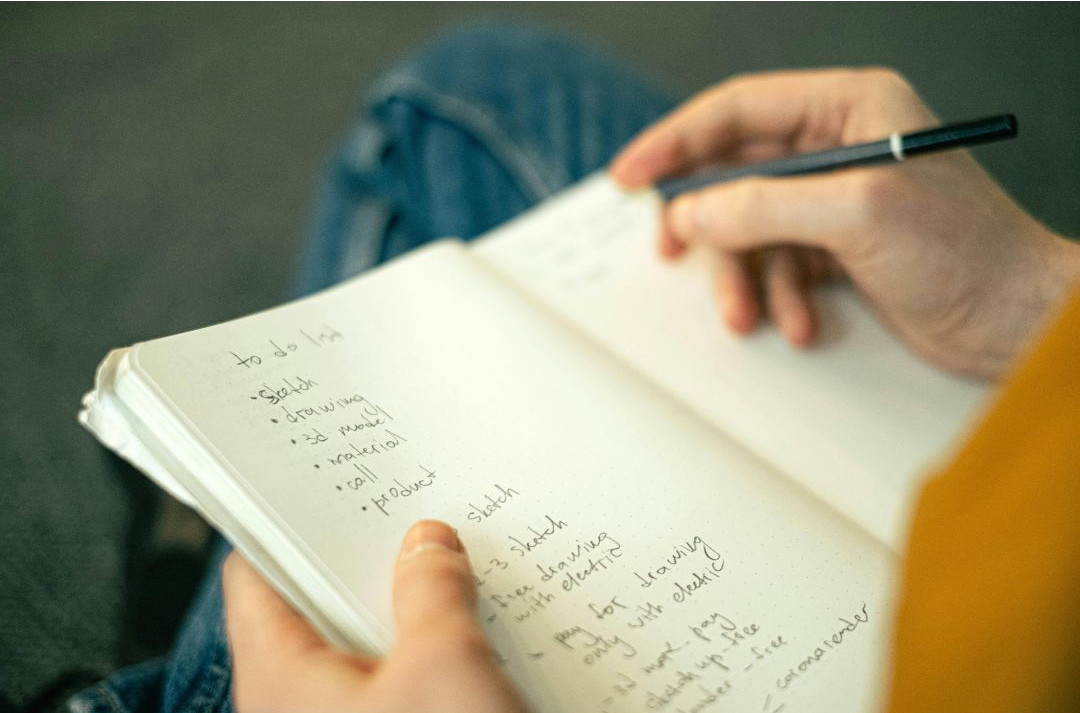 Teen writing a homework to-do list to organize evening tasks
