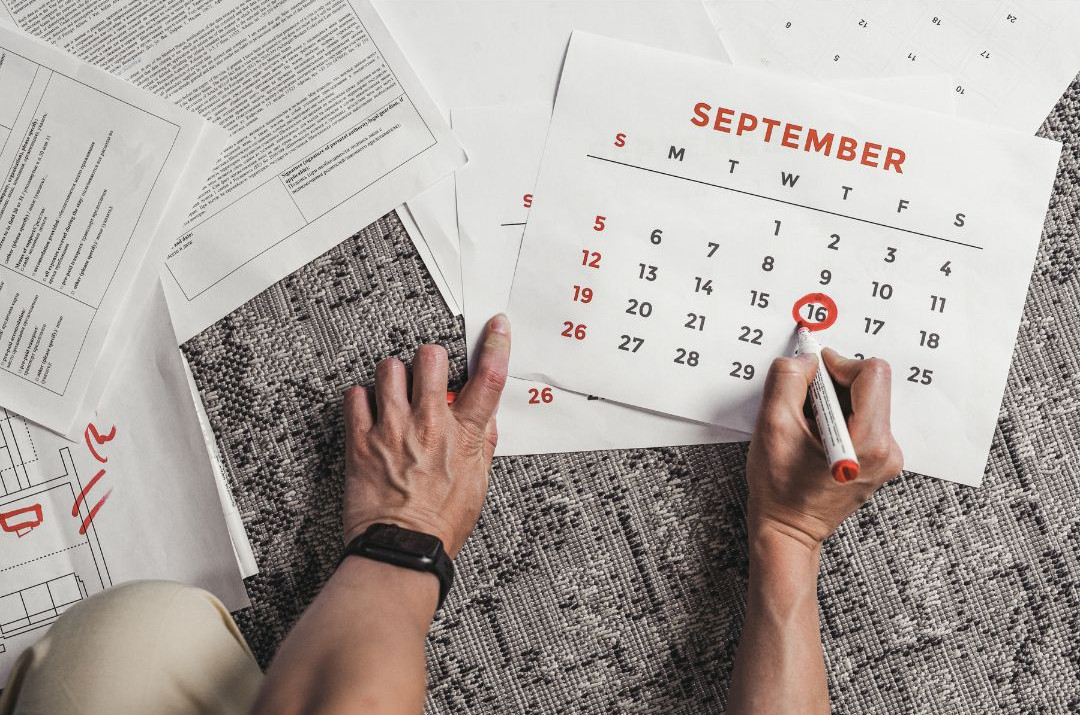 Teen planning homework and assignments on a calendar