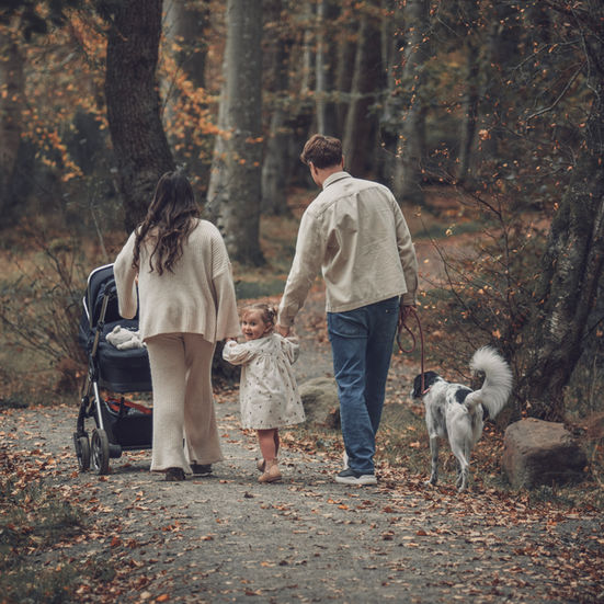 A natural lifestyle image capturing authentic family interaction in an outdoor setting, with an emphasis on emotion, movement, and real moments.