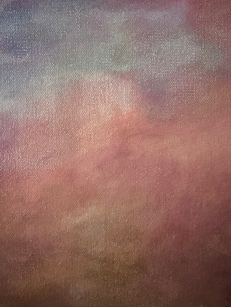 a close up of a canvas with a pink and blue sky