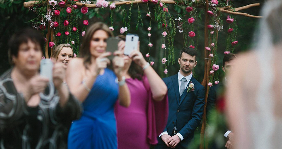 Guests only caring about the photo and not even seeing the bride