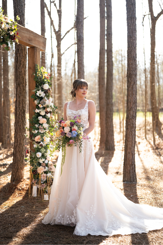 Bride in front of the arbor with faux floral arrangement by Faux Real Flowers Atlanta