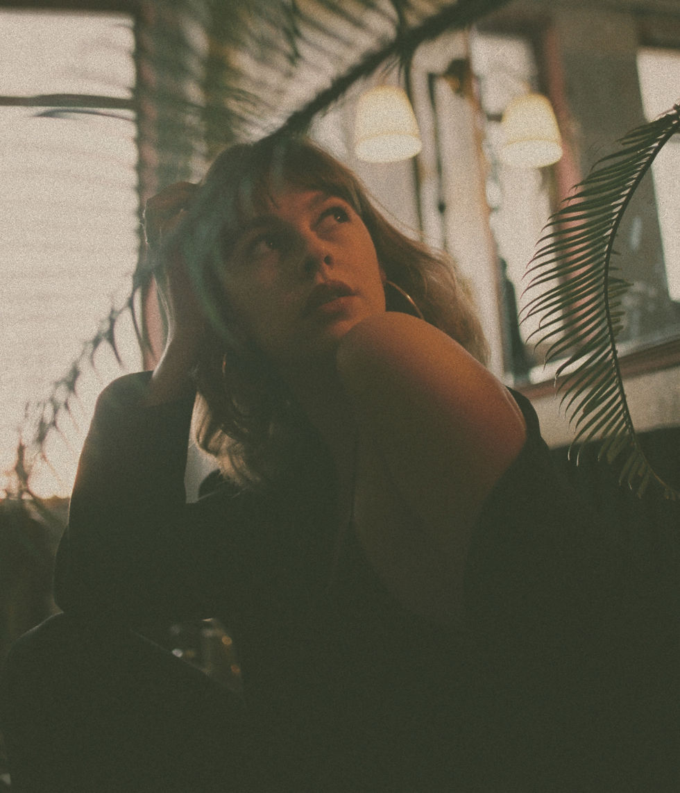 Reflective woman in warm lighting symbolizing confidence and becoming