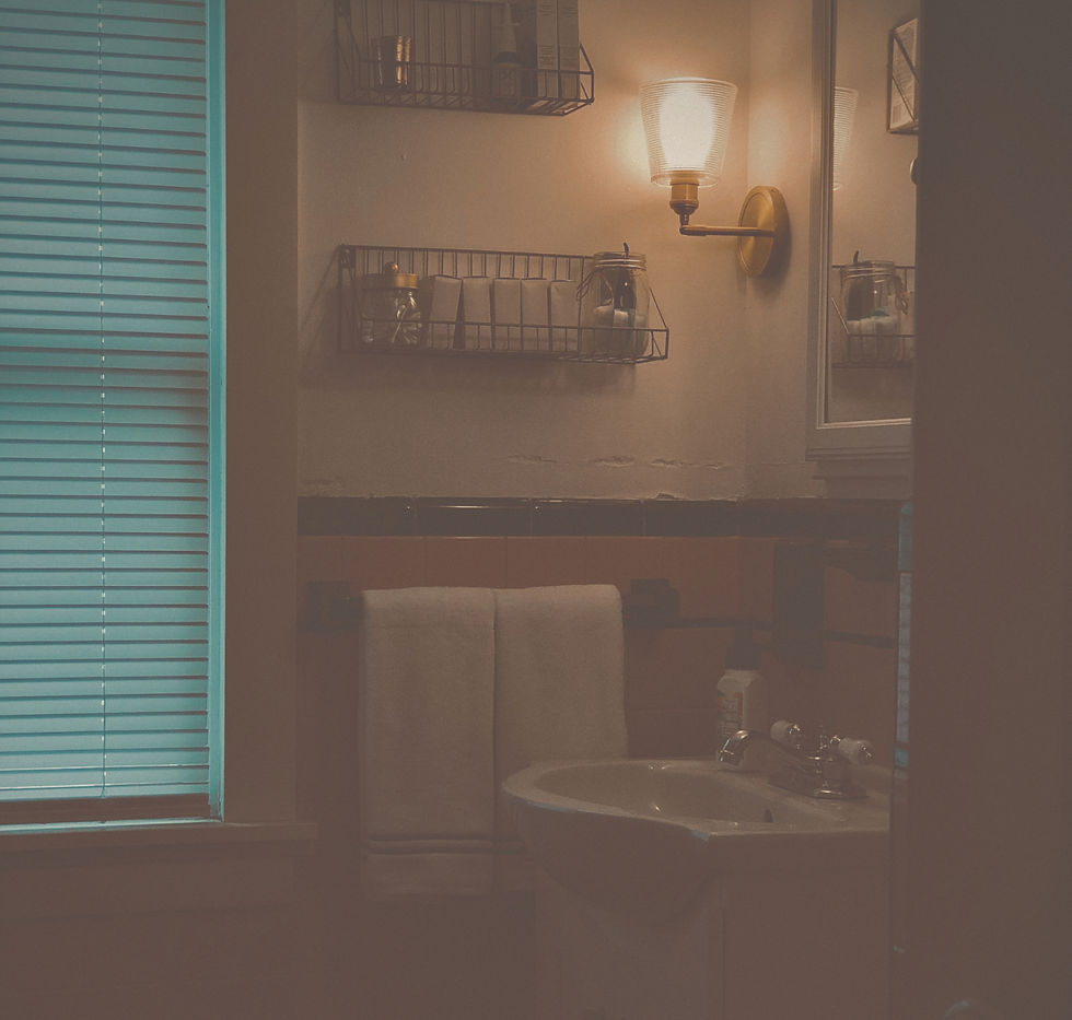 Warm bathroom with skincare products and soft lighting during an evening self-care ritual