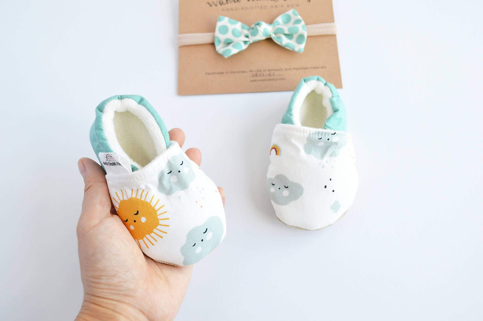 Thumbnail: hand holding baby shoes