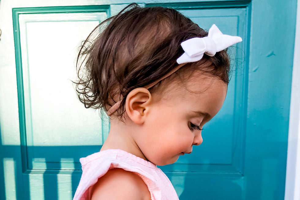 Thumbnail: toddler girl wearing a white hairbow