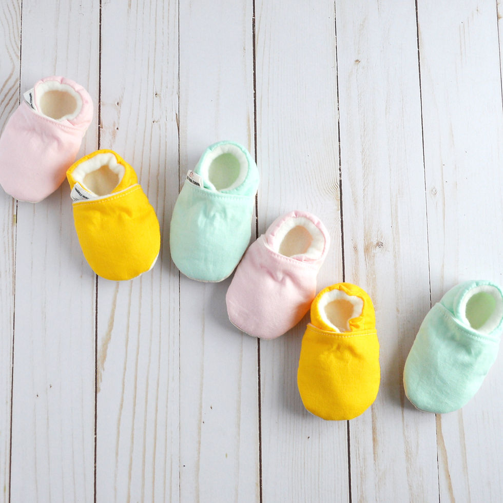 Thumbnail: pastel baby shoes in pink, mint, and yellow