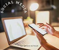 A laptop seated on a desk and a woman hands doing a scroll on her phone