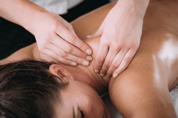 A woman receiving a deep tissue back massage at Signature Thai Clinic, promoting relaxation and well-being.