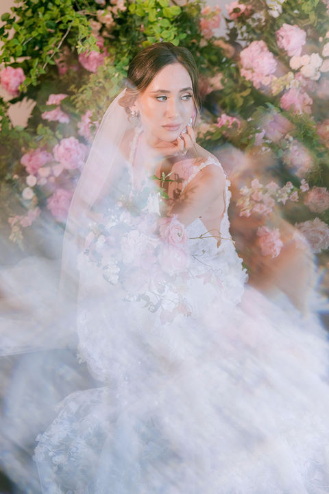 Detailed view of a lush wedding arch adorned with pink and green florals, creating a timeless and elegant atmosphere for a romantic Montreal wedding.