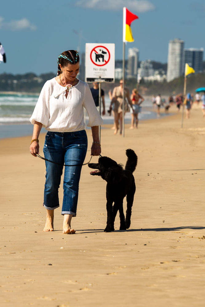 Vraja and Jackson the poodle walking on the beach
