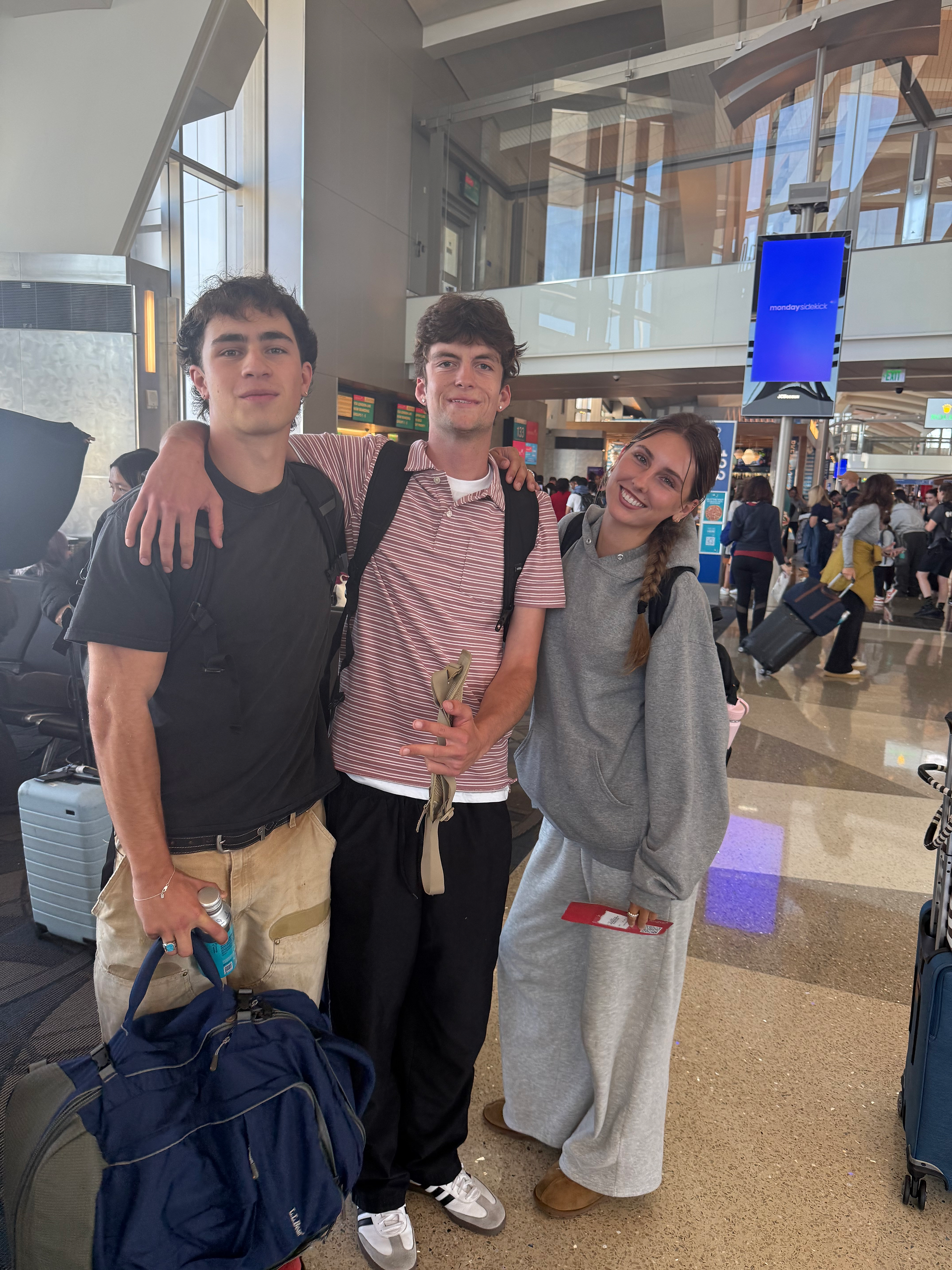 Sam Fegan, Lennon Sutphin and Savannah Whalen (me) smiling at the airport in a group photo