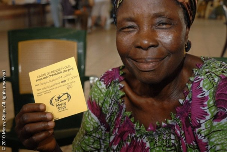 A Mercy Ships patient in Togo receives a card for surgery