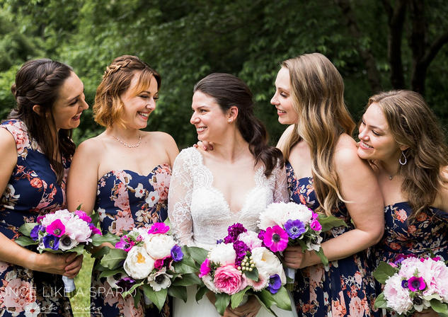 Bride and her bridesmaids in navy and pink floral dresses
