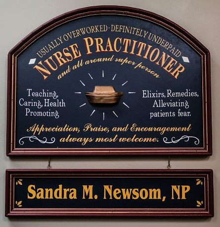 Nurse Practitioner wooden plaque hanging on a wall in the office
