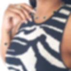 Thumbnail: Woman wearing black clover necklace and bracelet