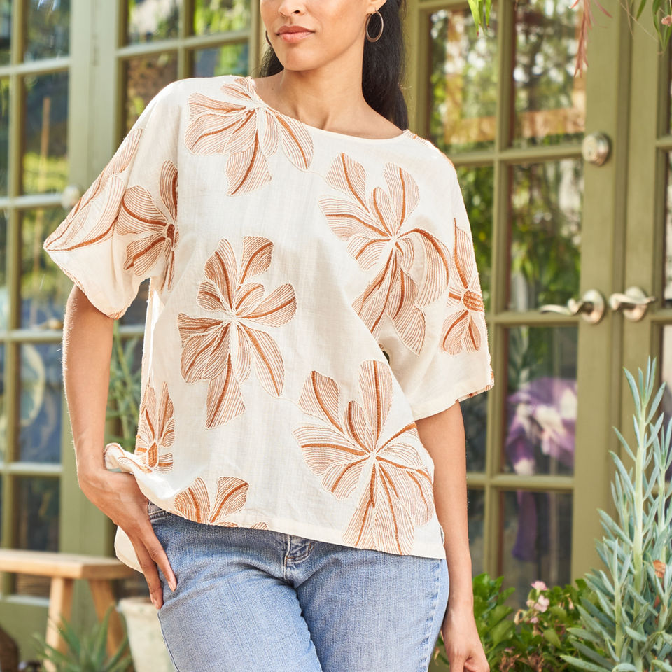Women’s embroidered short sleeve top in ivory with tonal floral embroidery.