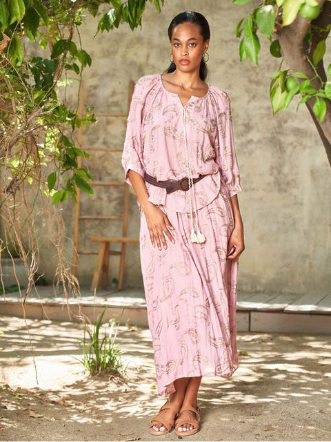 Pink paisley print matching set featuring a relaxed top and coordinating midi skirt, styled with a belted waist.