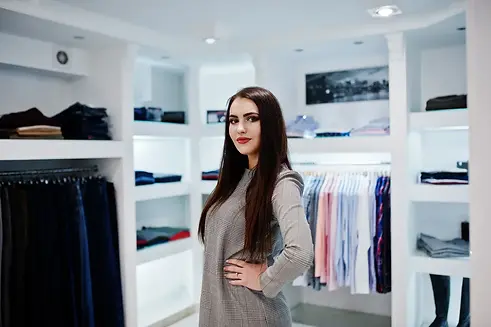 brunette-gorgeous-girl-clothing-store-boutique-gray-dress.webp