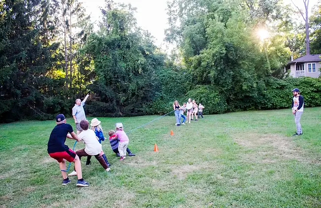 Neighbourhood kids take part in a game of tug of war before trying their hand at balancing