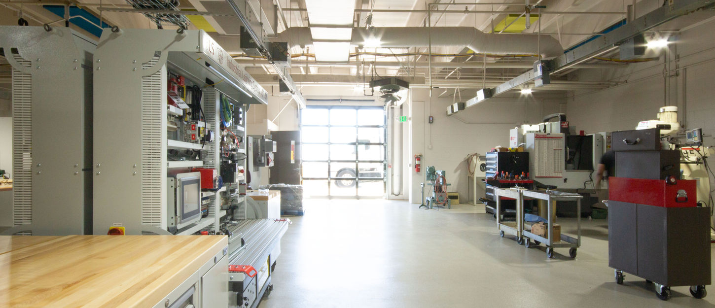 A glass overhead door floods the space with natural light making the manufacturing and work areas inviting and lively. 