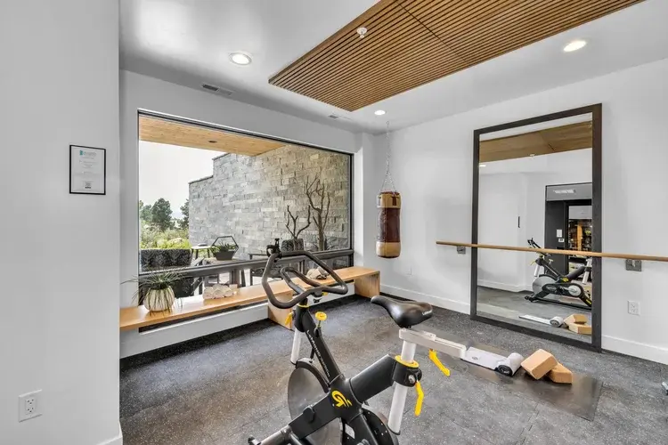 Home office with desk, large window, and natural light overlooking the landscape.