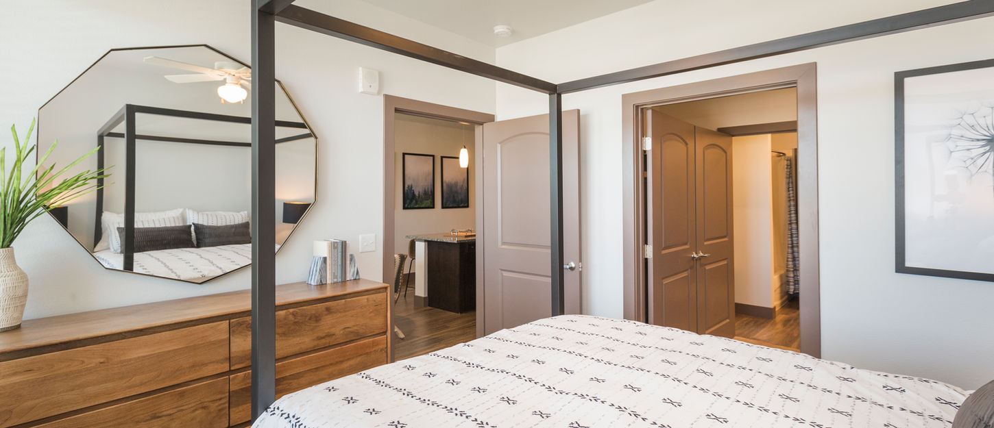 Light-filled bedroom with large windows and modern furnishings at Volta on Voyager.