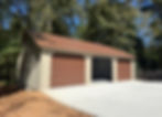 Three-car garage with brown doors