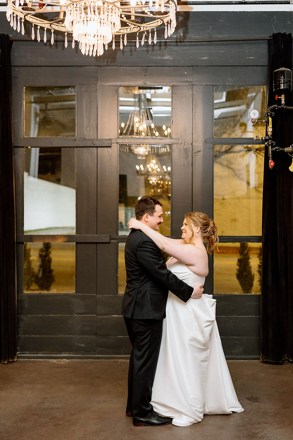 Emily and Mikel have their first dance in front of their guests during their 32-person wedding reception at The Fire House KC in Kansas City.