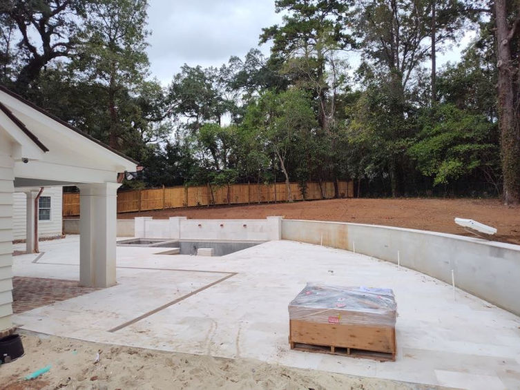 exterior of home with new retaining wall and new construction