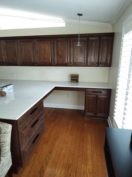 cherry wood floors and dark walnut cabinetry pull drawers on desk