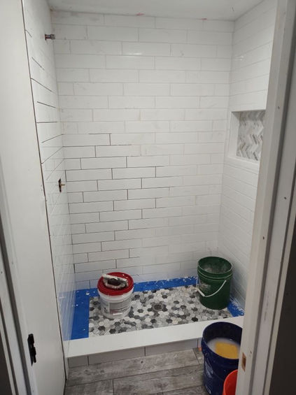 fresh pebble tile on the ground of the renovated shower