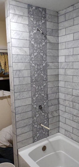 fancy filigree gray tile in a remodeled bathroom
