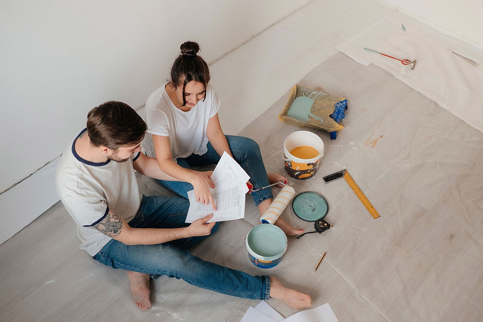 a man and a woman discuss home remodeling with supplies around