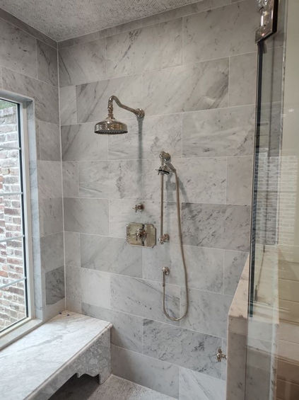 gray tiled shower wall with silver rain shower head