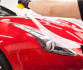 PPF installation on a red sport car. PPF is a short name for Paint Protection Film. .jpg