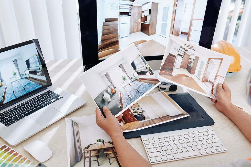Person reviewing various interior design concepts at a modern office desk.