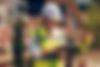 Woman in hard hat and safety vest writing on clipboard