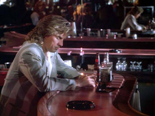 Don Johnson as Sonny Crockett sits at the bar at Mac's Club Deuce.